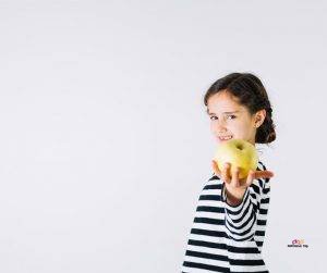 Featured image of girl in black and white offering apple