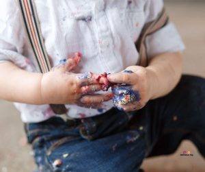 Featured image of dirty baby with cake on hands