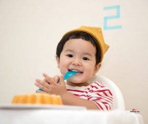 Featured image of cute toddler eating birthday cake