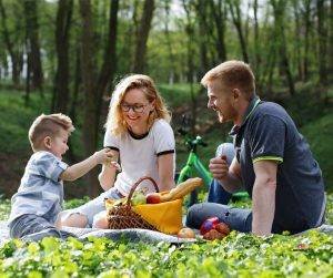 Featured image of happy parents and boy in park on picnic