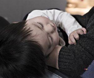 Featured image of baby boy sleeping in parents arms