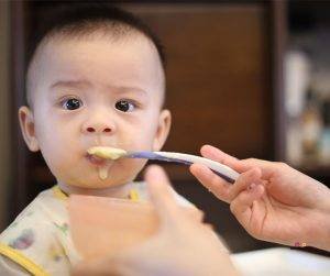 Featured image of cute baby being spoon fed