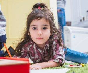Featured image of cute little girl drawing on floor