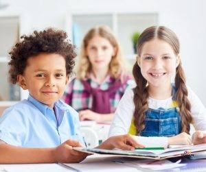 Featured image of girl and boy with notebooks sitting in class