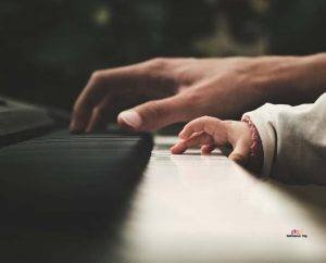 little girl playing a piano